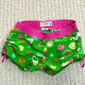 Roxy Girls Swim Shorts in Vibrant Green and Pink with scrunch side tie on leg.